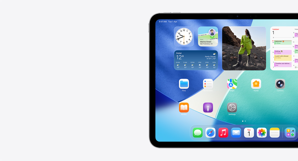 iPad, landscape orientation, left side of screen only, Home Screen with stacked widgets including translucent clock showing Liquid Glass effect, Find My app, Weather widget, two rows of smaller apps, and the dock