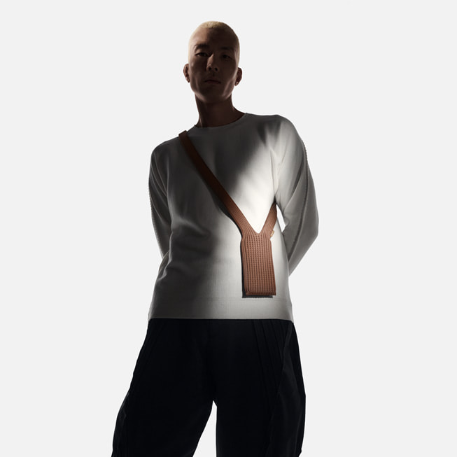 A user poses with iPhone Pocket in cinnamon.