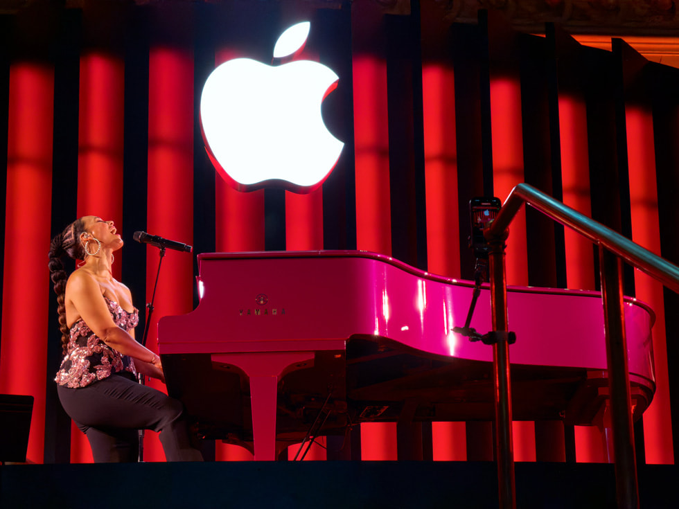 Alicia Keys sits at her piano as she performs at Apple Grand Central.