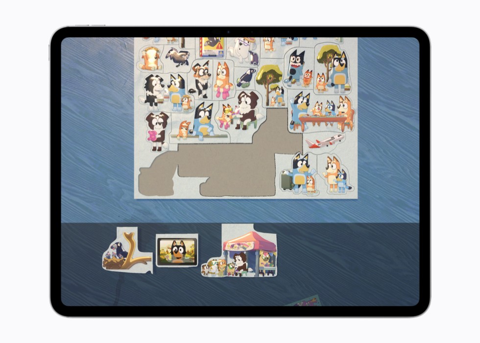 A still from the game puffies. on iPad shows a sticker book page with different “Bluey” characters.