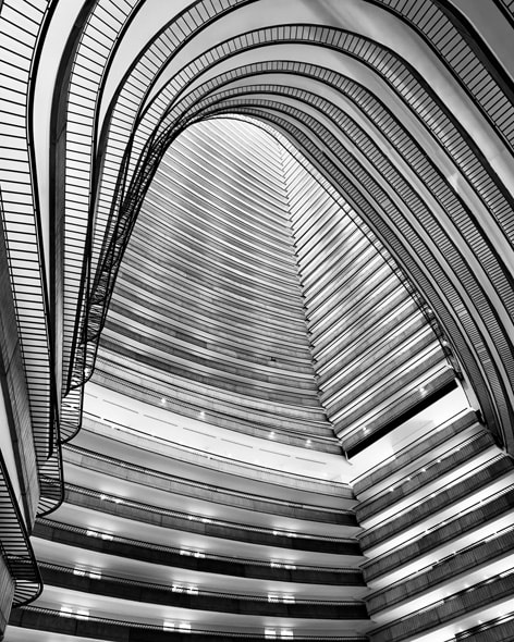 A black-and-white photo of the towering atrium inside an iconic Atlanta hotel. Shot on iPhone 16 Pro Max by Stephen Vanasco.